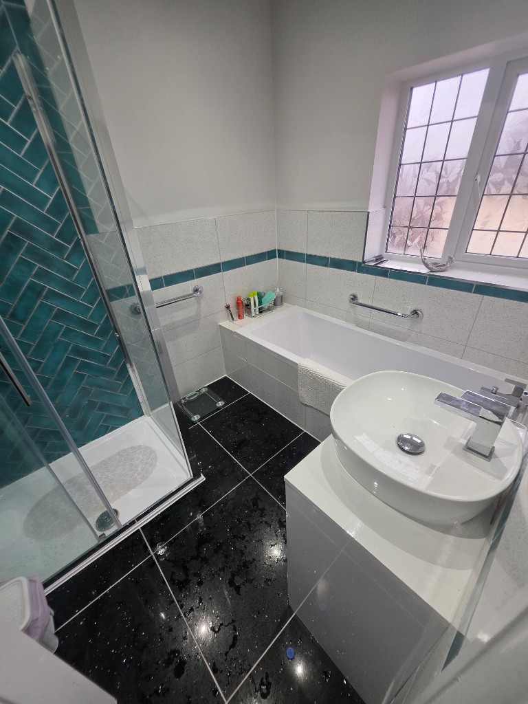 Full room view — bath, shower and vanity in Barrowford