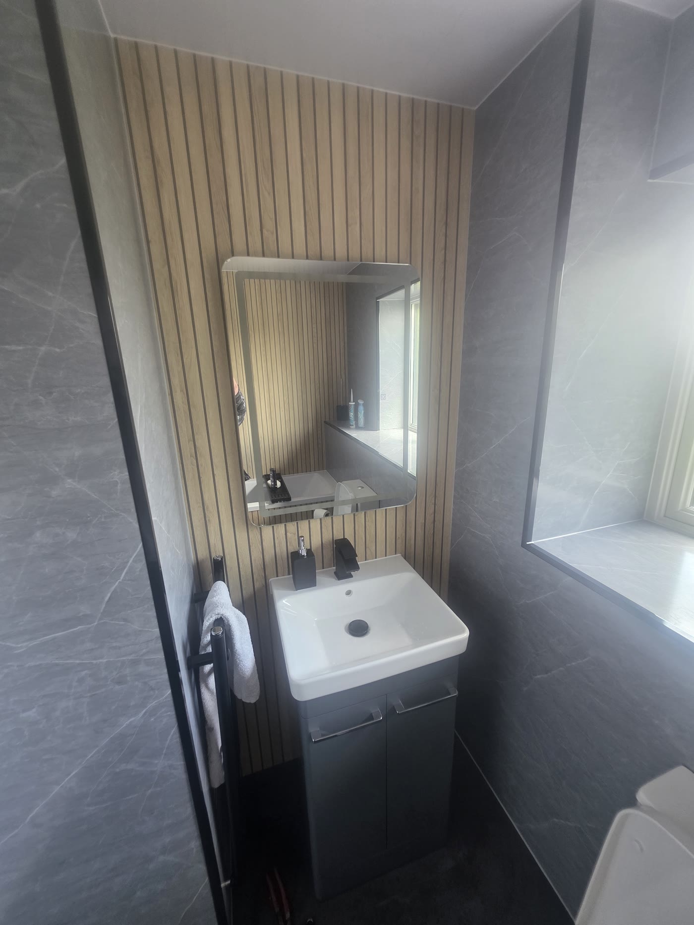 Vanity, LED mirror and wood-slat accent wall