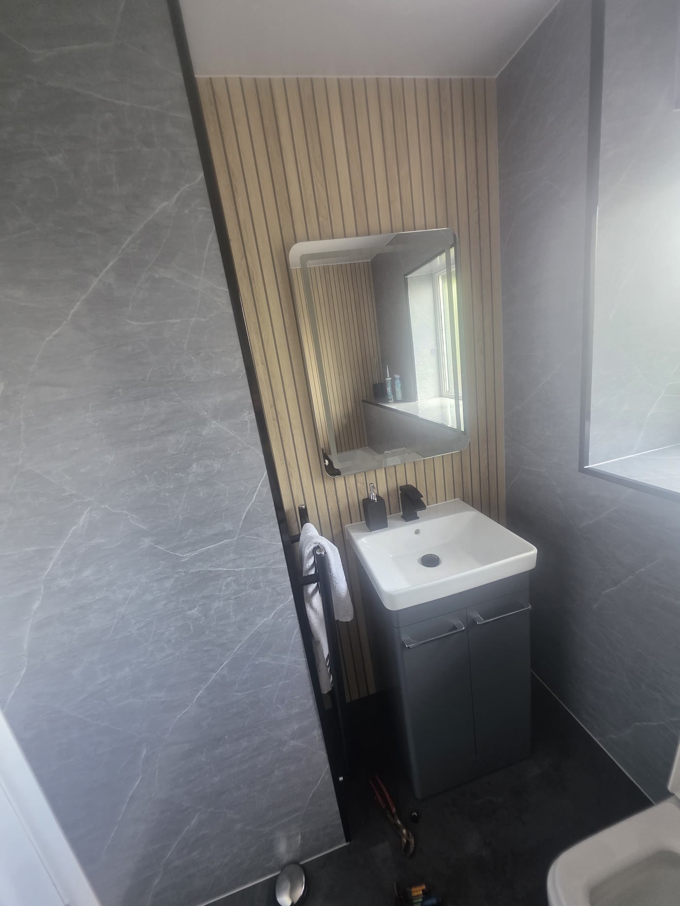 Vanity corner with matte black fittings and heated towel rail