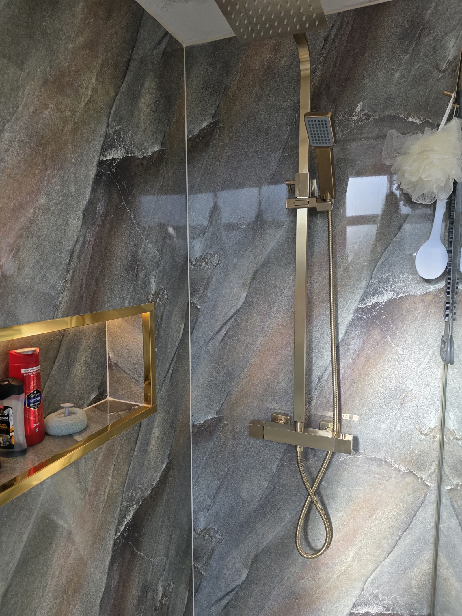 Rainfall shower, handheld rail and gold-trimmed illuminated niche