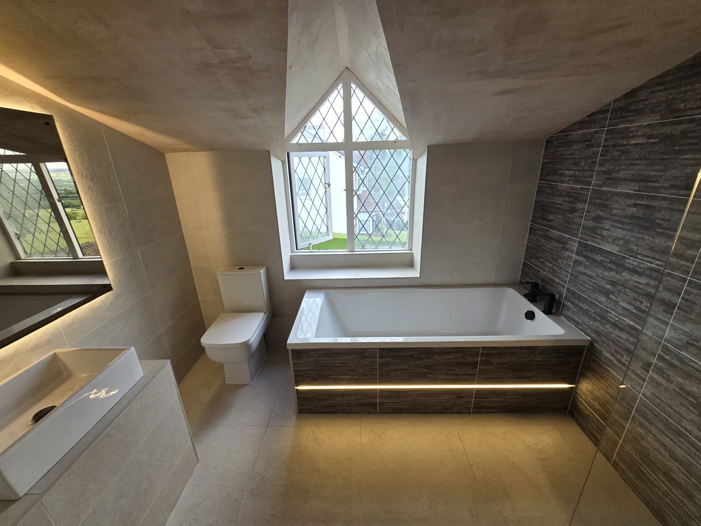 Finished Hapton bathroom with LED bath panel, 4D LED mirror and leaded feature window