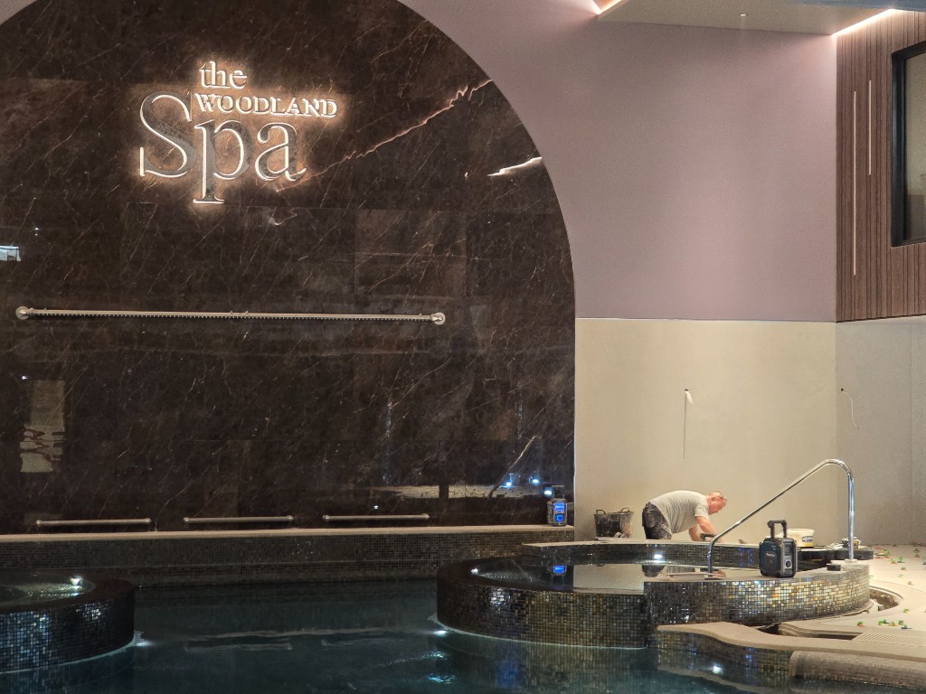 The WOODLAND Spa feature wall and poolside tiling in progress