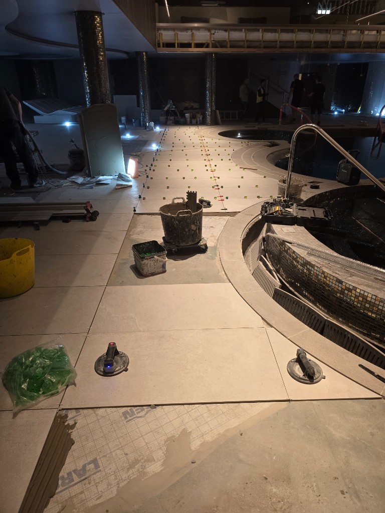 Tile leveling system across large-format spa floor tiles